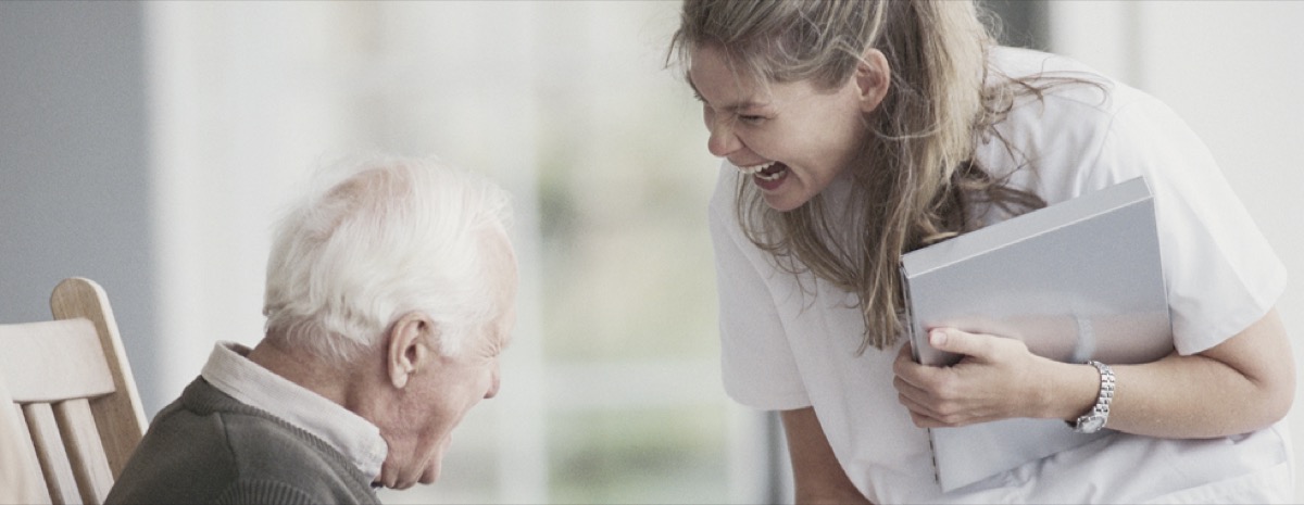 A caregiver with a client outside their home